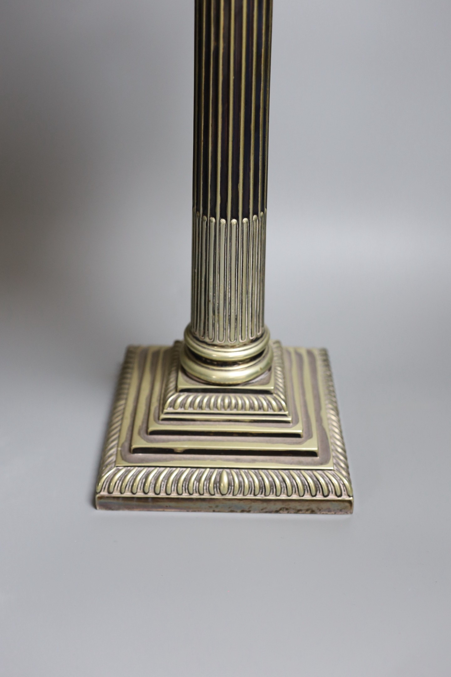 A Victorian silver plated Corinthian column oil lamp, with a glass reservoir